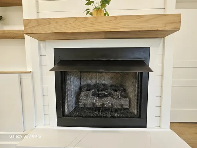 a black and white wall with a fireplace