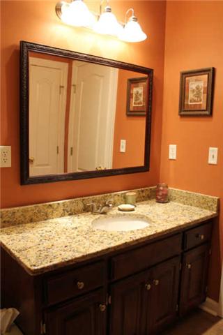 128 Hunters Ridge Drive Tullahoma, TN 37388 - Photo 16 of 20 The Guest Bathroom features Granite Counter Tops and Upgraded Lighting and Mirror