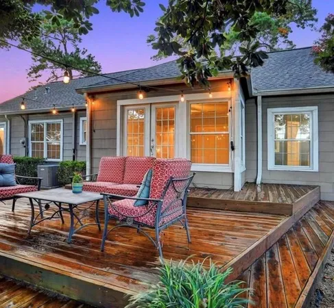 a view of a house with backyard and sitting area