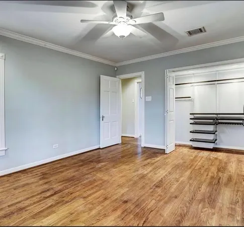 a view of an empty room with a ceiling fan