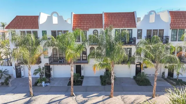 a front view of a multi story building with yard