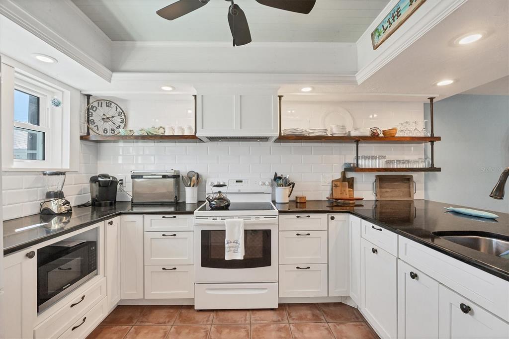 530 5th Street West, Unit 4 Boca Grande, FL 33921 - Photo 18 of 48 a kitchen with stainless steel appliances granite countertop a sink and cabinets