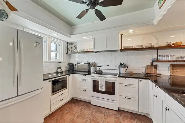 a kitchen with stainless steel appliances kitchen island granite countertop a sink and cabinets