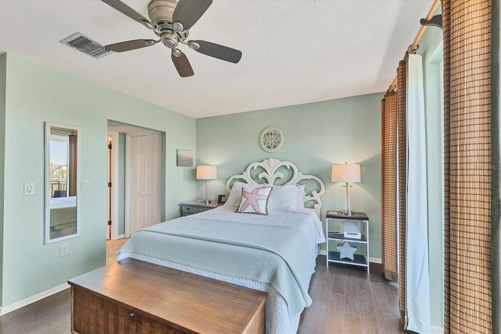 530 5th Street West, Unit 4 Boca Grande, FL 33921 - Photo 26 of 48 a bedroom with a bed and a chandelier