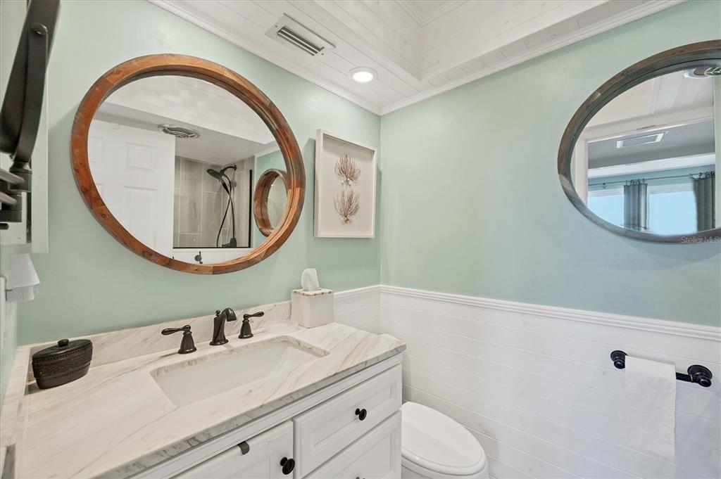 530 5th Street West, Unit 4 Boca Grande, FL 33921 - Photo 29 of 48 a bathroom with a toilet a sink and a mirror