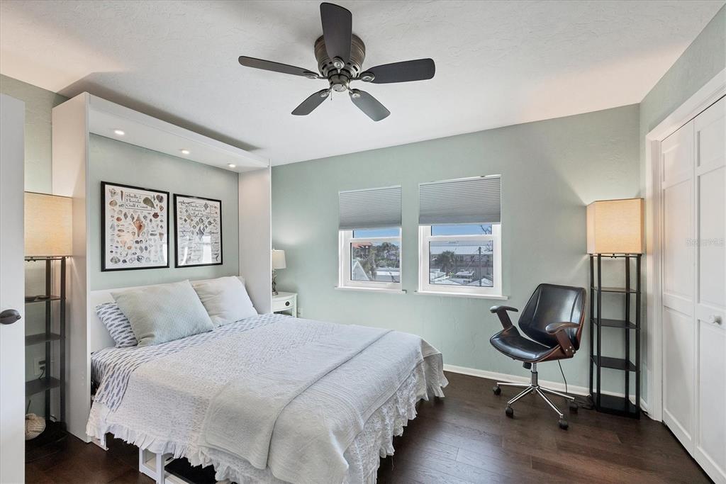 530 5th Street West, Unit 4 Boca Grande, FL 33921 - Photo 31 of 48 a bedroom with a bed and a chair