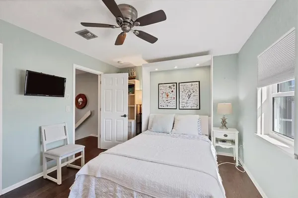 a bathroom with a granite countertop sink mirror vanity and toilet