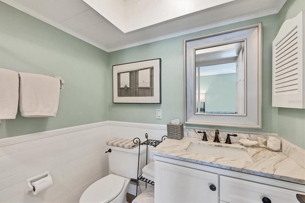 530 5th Street West, Unit 4 Boca Grande, FL 33921 - Photo 33 of 48 a bathroom with a granite countertop sink mirror vanity and toilet