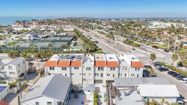 an aerial view of residential houses with outdoor space