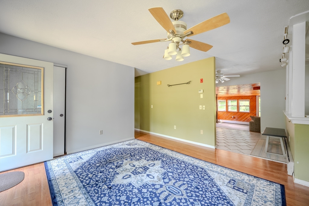 71 Webber Road Brookfield, MA 01506 - Photo 13 of 41 a view of a hallway with wooden floor and chandelier