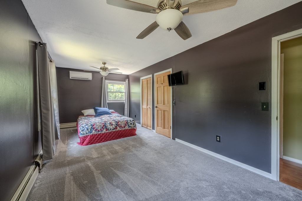 71 Webber Road Brookfield, MA 01506 - Photo 21 of 41 a bedroom with a bed and a chandelier