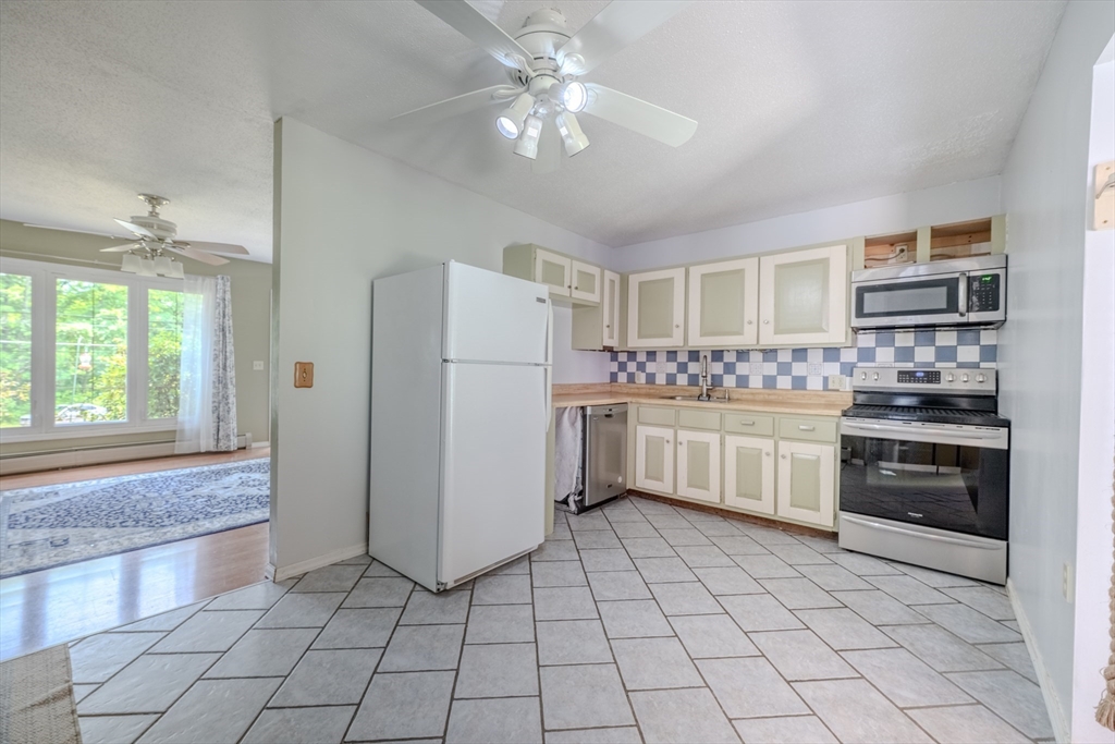 71 Webber Road Brookfield, MA 01506 - Photo 3 of 41 a kitchen with white cabinets and white appliances