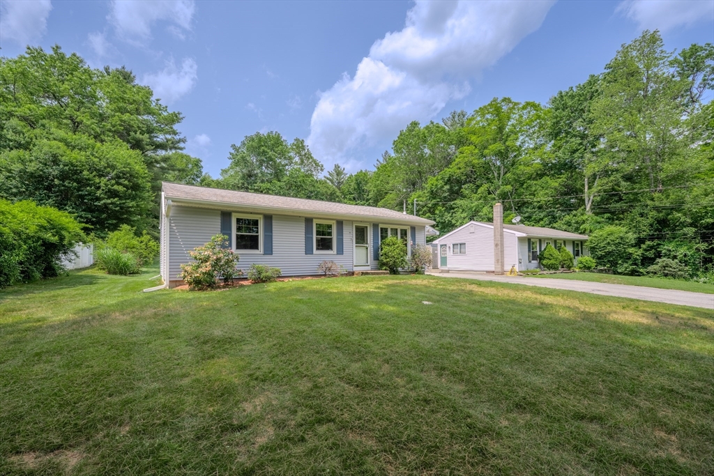 71 Webber Road Brookfield, MA 01506 - Photo 33 of 41 a front view of a house with a yard and trees