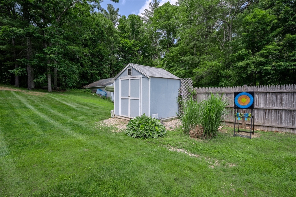 71 Webber Road Brookfield, MA 01506 - Photo 36 of 41 a view of a backyard with a barn and large trees