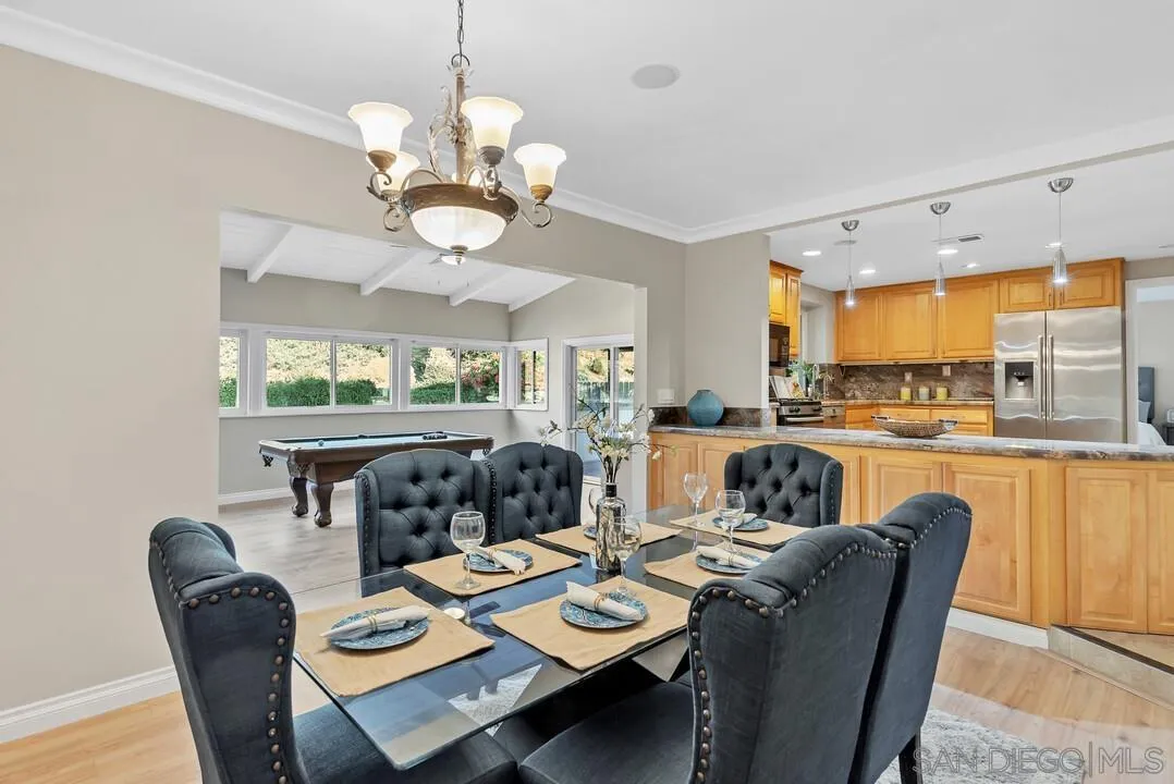 9651 Ramsgate Way Santee, CA 92071 - Photo 15 of 52 a view of a dining room with furniture a chandelier and wooden floor