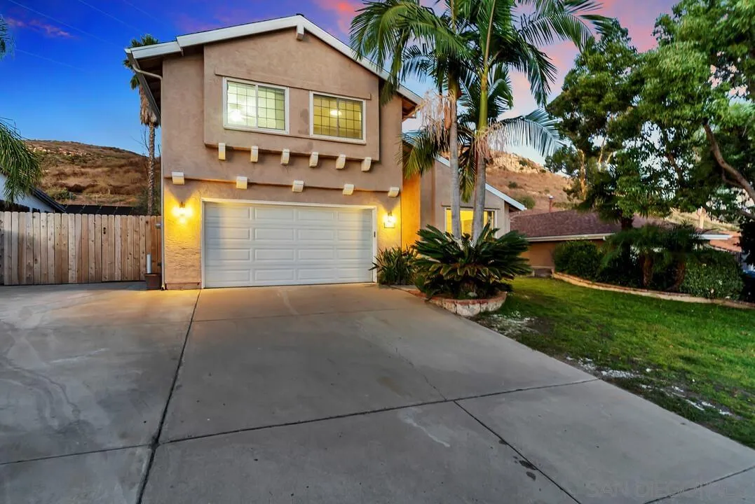 9651 Ramsgate Way Santee, CA 92071 - Photo 3 of 52 a front view of a house with a yard and garage