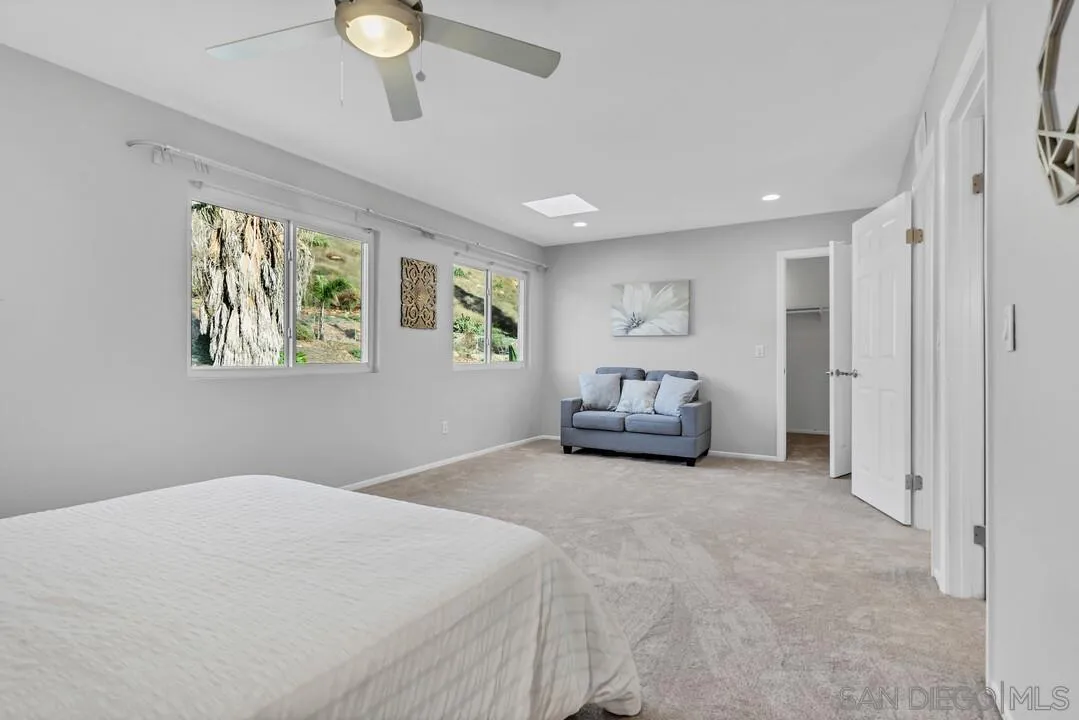 9651 Ramsgate Way Santee, CA 92071 - Photo 38 of 52 a bedroom with a bed and a chandelier