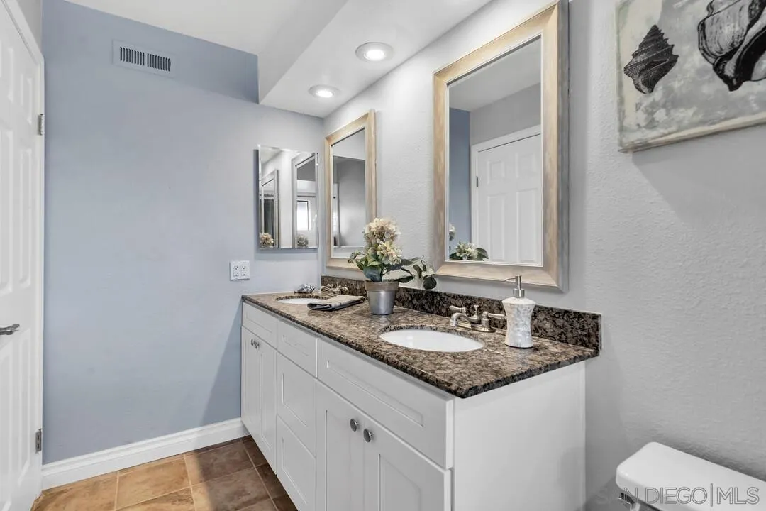 9651 Ramsgate Way Santee, CA 92071 - Photo 40 of 52 a bathroom with a granite countertop sink and a mirror
