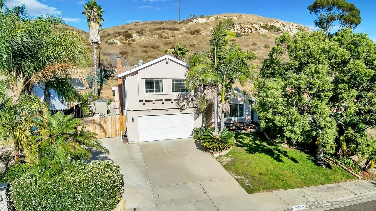 9651 Ramsgate Way Santee, CA 92071 - Photo 4 of 52 a front view of a house with a yard