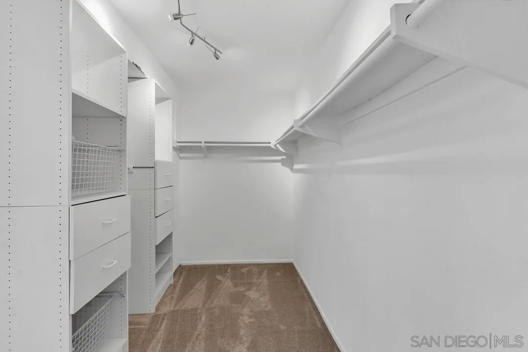 9651 Ramsgate Way Santee, CA 92071 - Photo 44 of 52 a view of walk in closet with empty racks