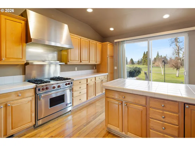 a kitchen with a stove a sink and a refrigerator