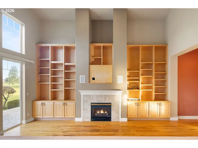 a view of a livingroom with a fireplace and windows