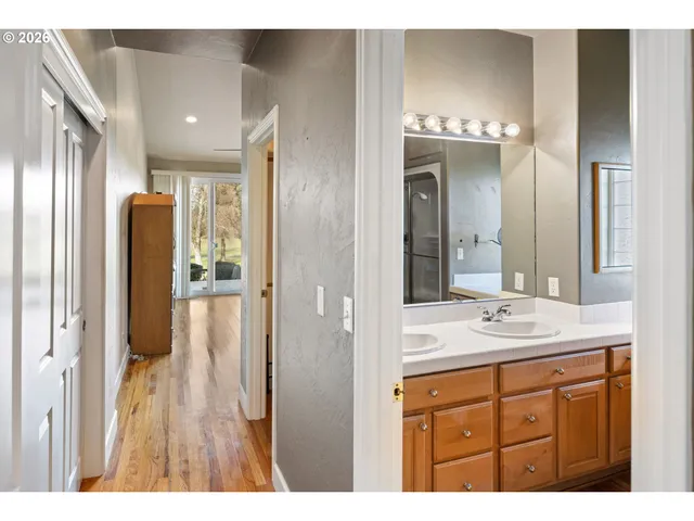 a bathroom with a sink a mirror and a shower