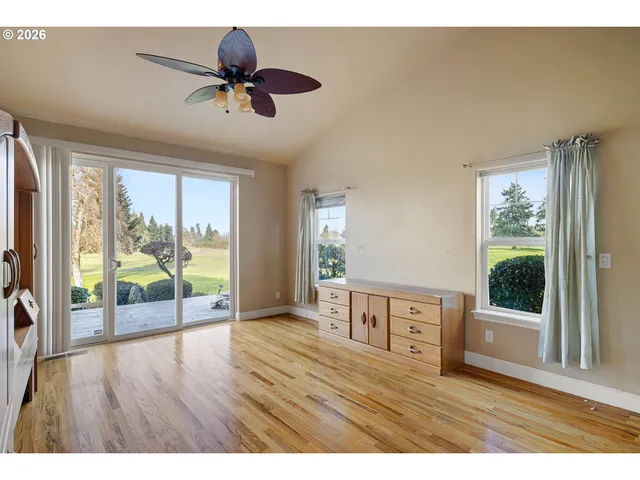 a living room with hardwood floor and a ceiling fan