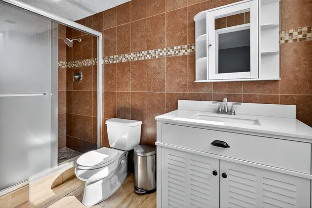 a bathroom with a sink mirror and toilet