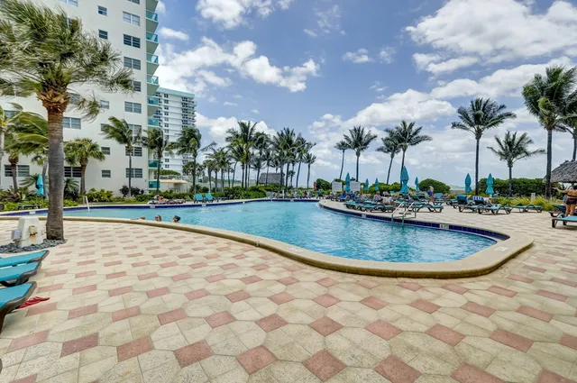 a view of swimming pool with outdoor seating