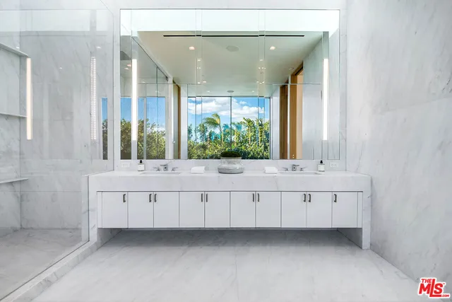 a bathroom with a white vanity and a large window