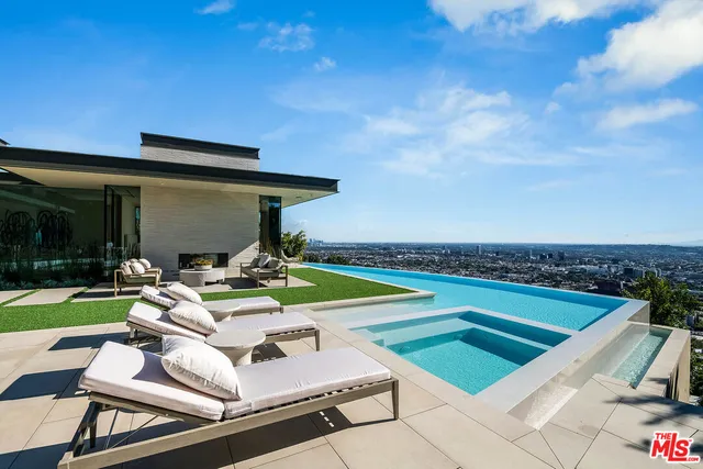 a view of a patio with swimming pool table and chairs