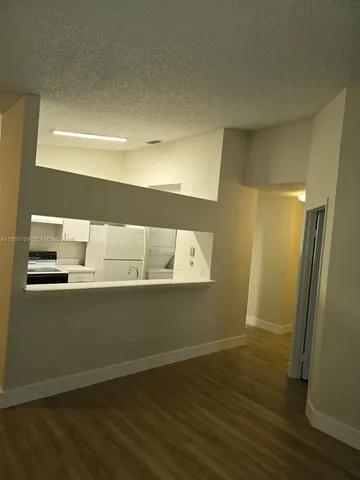 a room with wooden floor and entrance