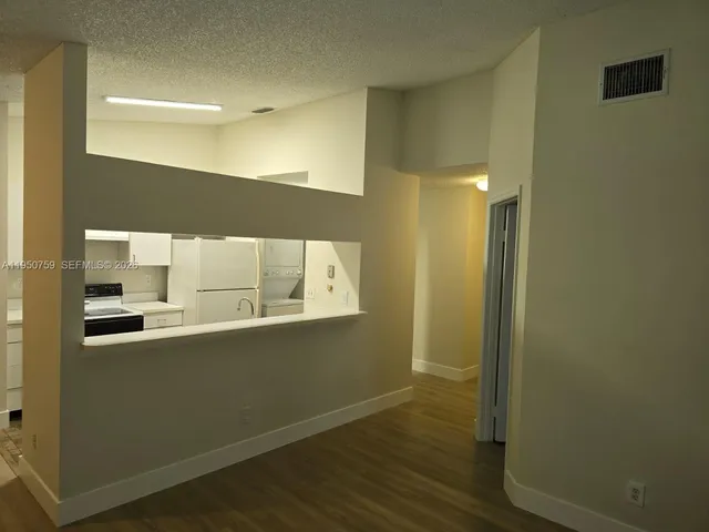 a view of a bathroom with sink and wooden floor