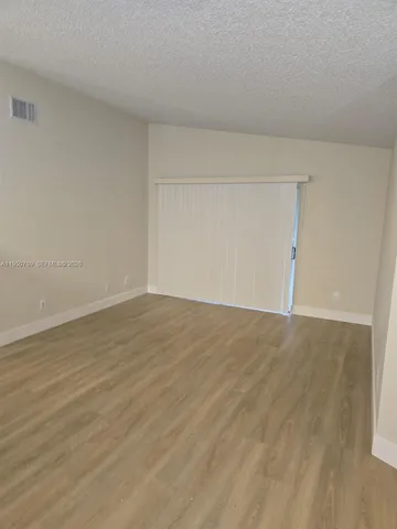 an empty room with wooden floor