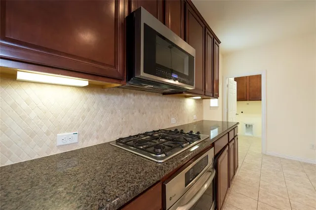 a kitchen with a stove and a microwave