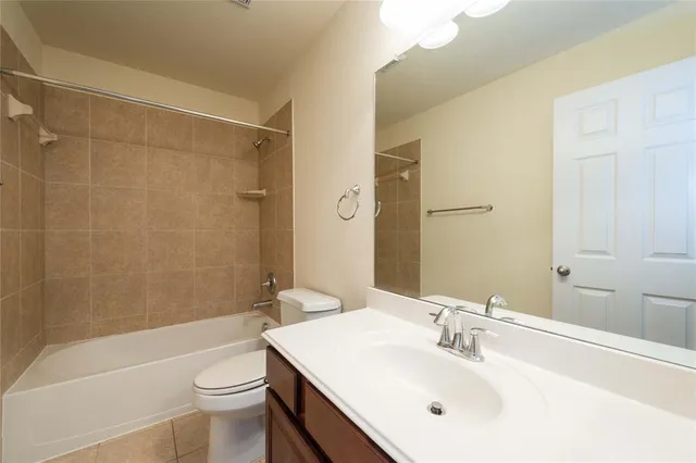 a bathroom with a sink mirror toilet and bathtub