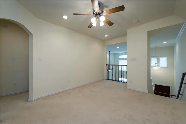 an empty room with a ceiling fan and a bathroom