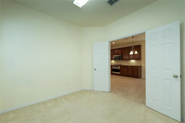 a view of an empty room and chair and fire place