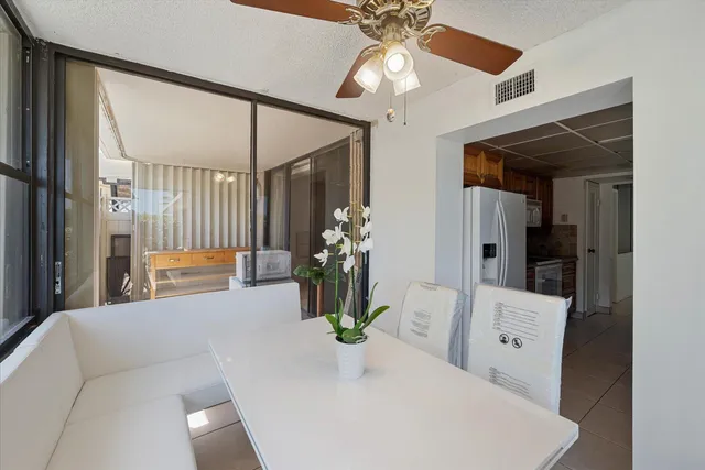 a living room with furniture and flowers
