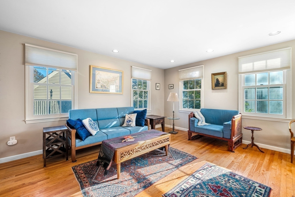 33 Pleasant Street, Unit 33 Manchester, MA 01944 - Photo 11 of 40 a living room with furniture a rug and a window