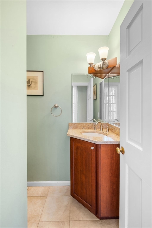 33 Pleasant Street, Unit 33 Manchester, MA 01944 - Photo 12 of 40 a view of a kitchen with a refrigerator and a stove