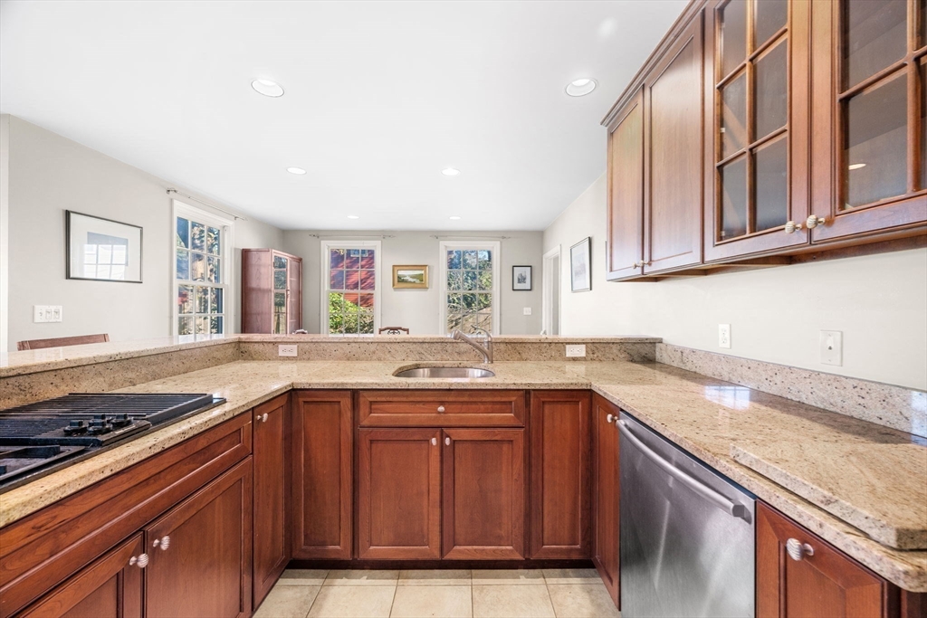 33 Pleasant Street, Unit 33 Manchester, MA 01944 - Photo 13 of 40 a kitchen with stainless steel appliances granite countertop a sink stove and cabinets