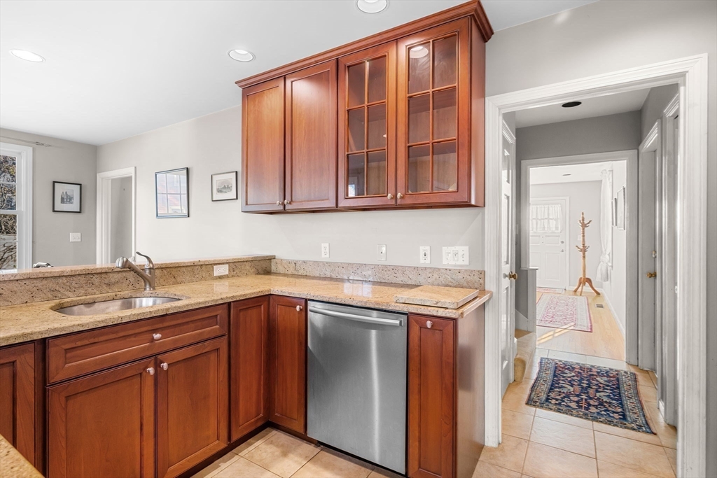 33 Pleasant Street, Unit 33 Manchester, MA 01944 - Photo 14 of 40 a kitchen with a sink stove and cabinets