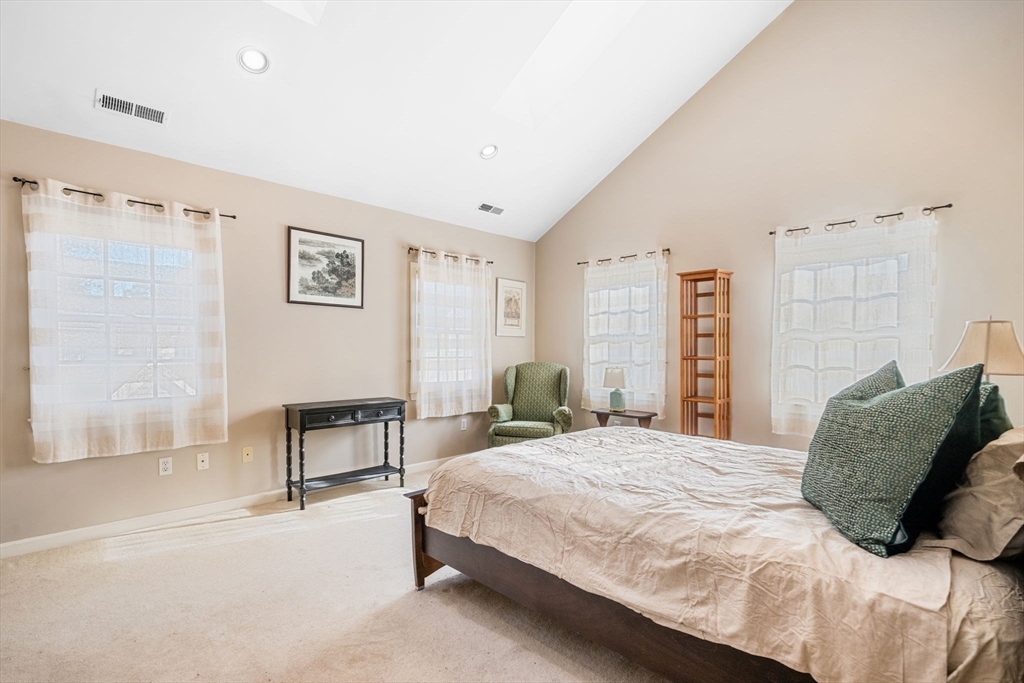 33 Pleasant Street, Unit 33 Manchester, MA 01944 - Photo 19 of 40 a bedroom with a bed and a table