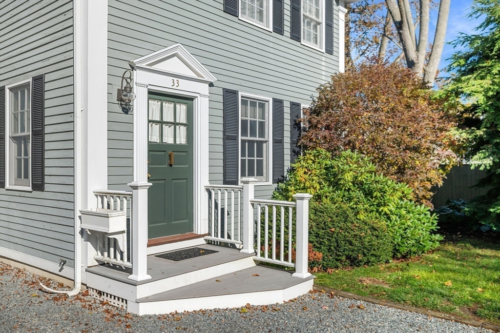 33 Pleasant Street, Unit 33 Manchester, MA 01944 - Photo 2 of 40 a front view of a house with fence