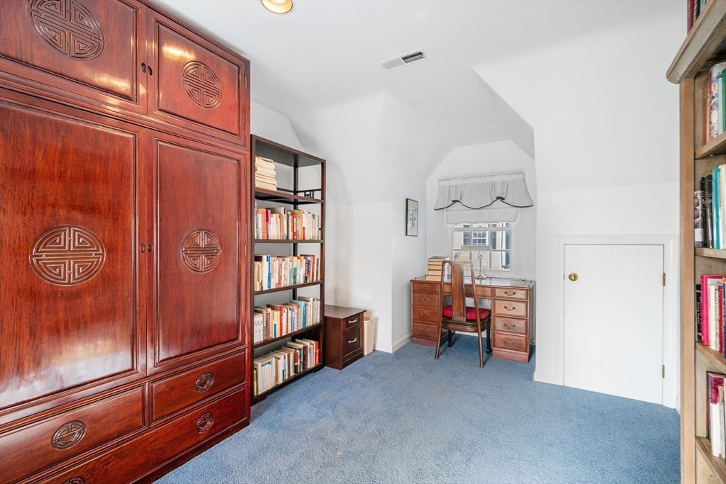 33 Pleasant Street, Unit 33 Manchester, MA 01944 - Photo 23 of 40 a view of a bedroom with baby crib and furniture