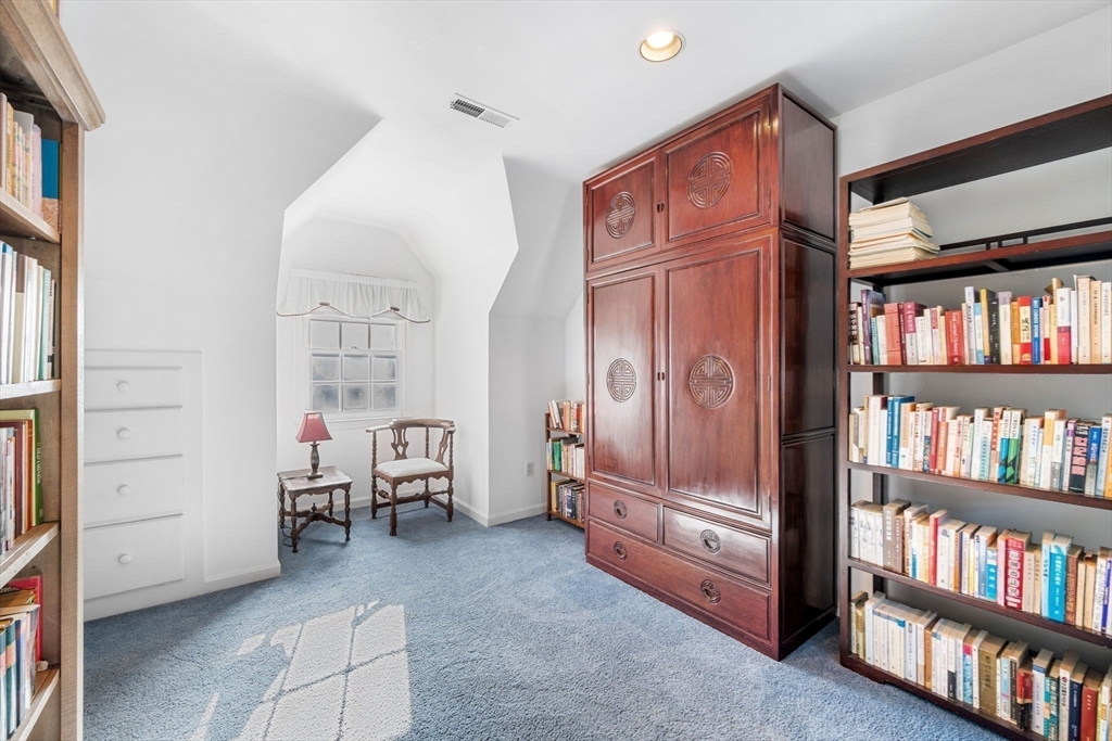 33 Pleasant Street, Unit 33 Manchester, MA 01944 - Photo 24 of 40 a living room with furniture and a book shelf