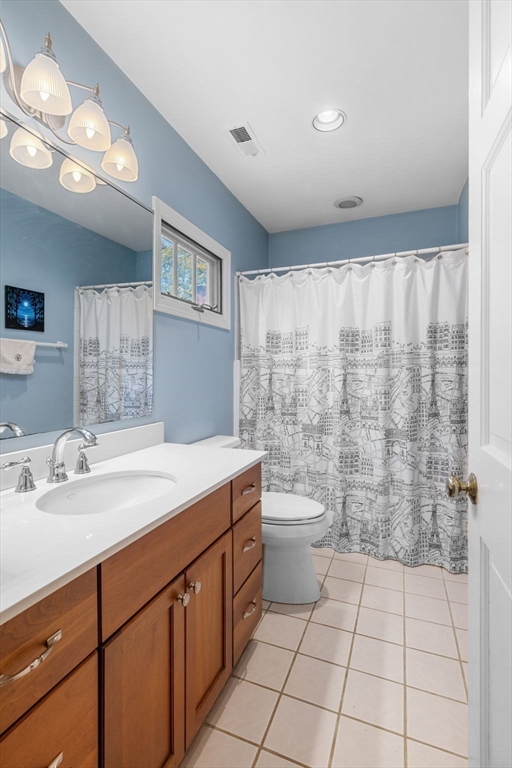33 Pleasant Street, Unit 33 Manchester, MA 01944 - Photo 26 of 40 a bathroom with a sink a toilet and a mirror