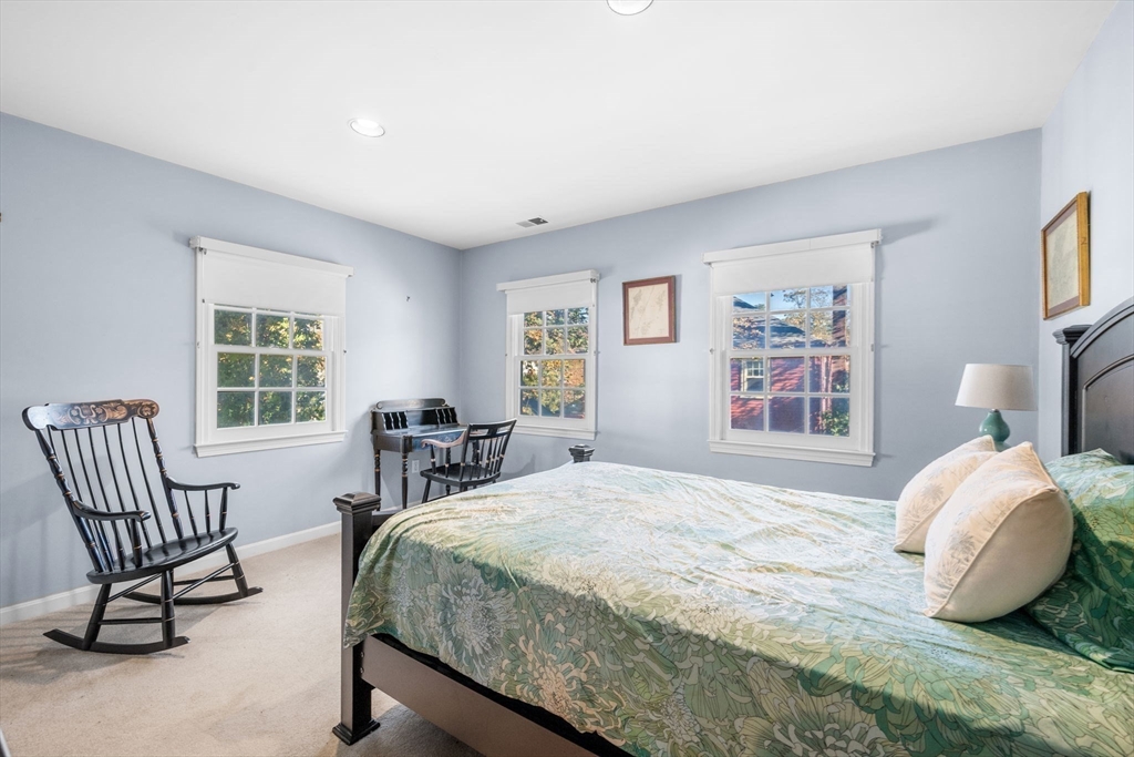 33 Pleasant Street, Unit 33 Manchester, MA 01944 - Photo 27 of 40 a bedroom with a bed chair and window